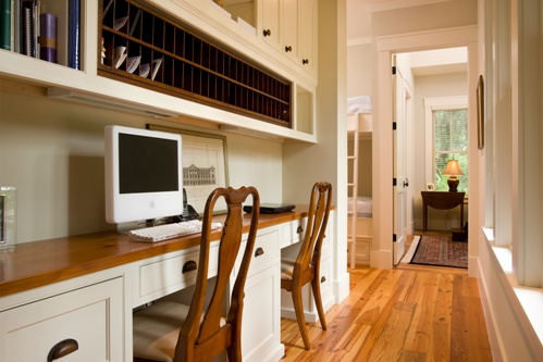 This hallway was designed to incorporate a built-in desk for the owners.  All the custom storage cubies help sort mail and keep paper clutter off the counter.