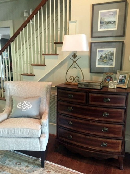 A modern wing chair and new chest add style to the living room.